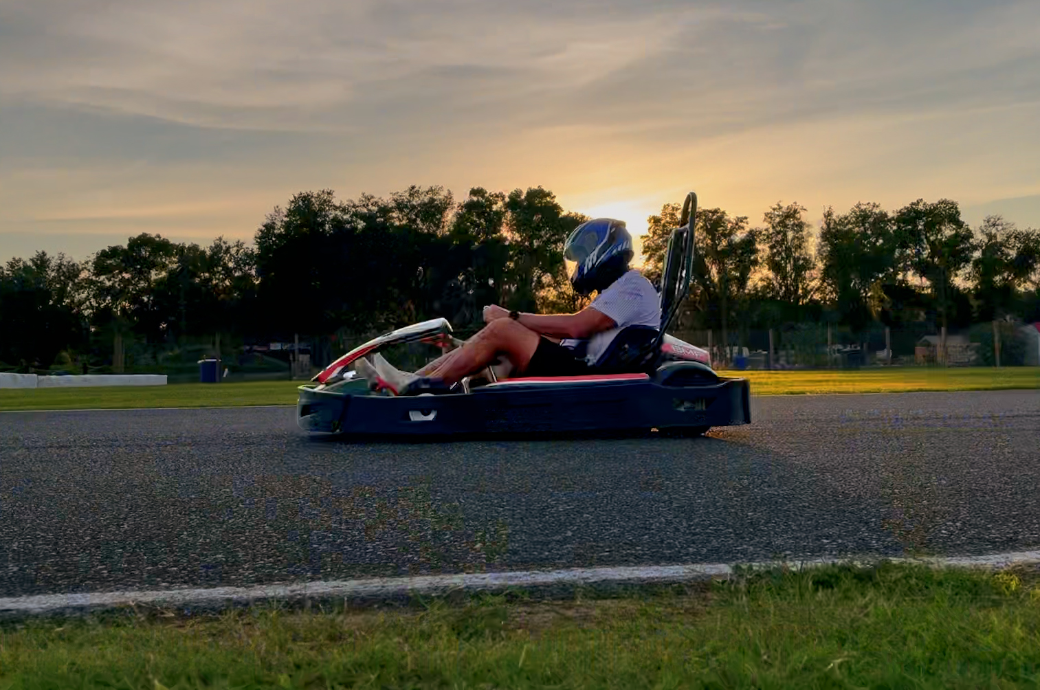 Competitive kart drivers in helmets racing at Bushnell Motorsports Park